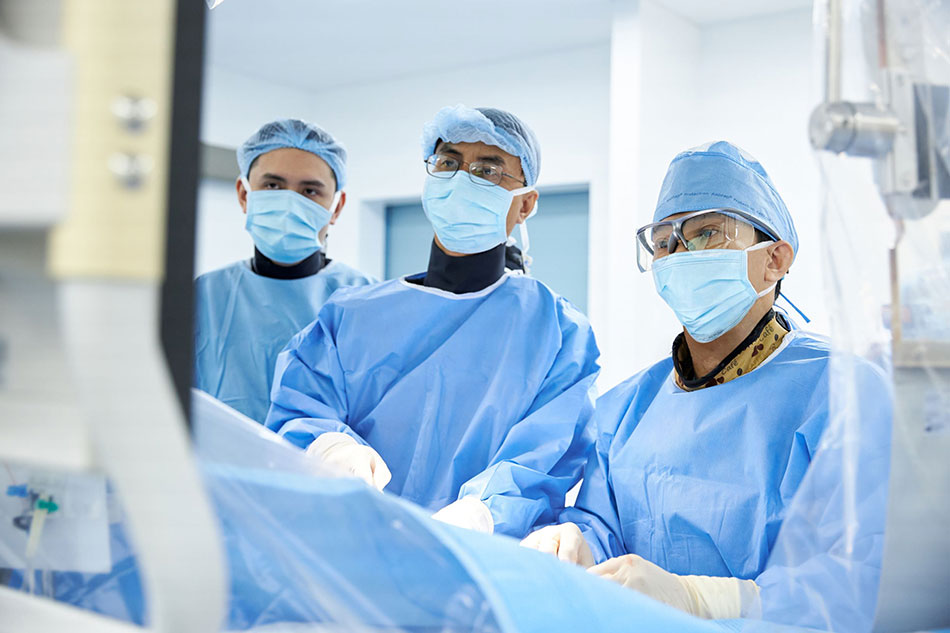 Dr Ho Minh Tuan and the medical team perform surgery in the Cardiac Cathlab