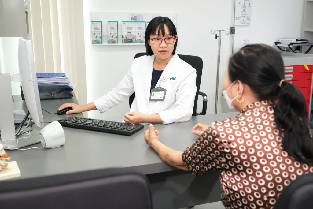 Dr Nguyen Nam Binh, Pain Clinic, FV Hospital, is examining a patient.