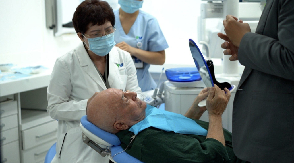 Lam Hoai Phuong, MD, PhD, examines Mr Gilbert Engelmann. 