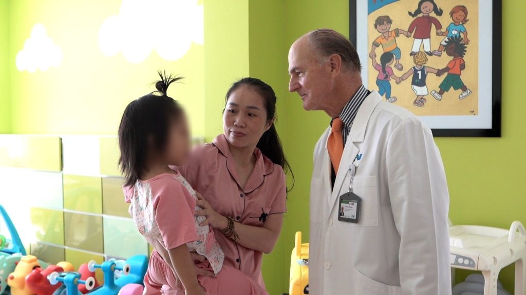 Prof. McKinnon visits patient Nhi after the surgery