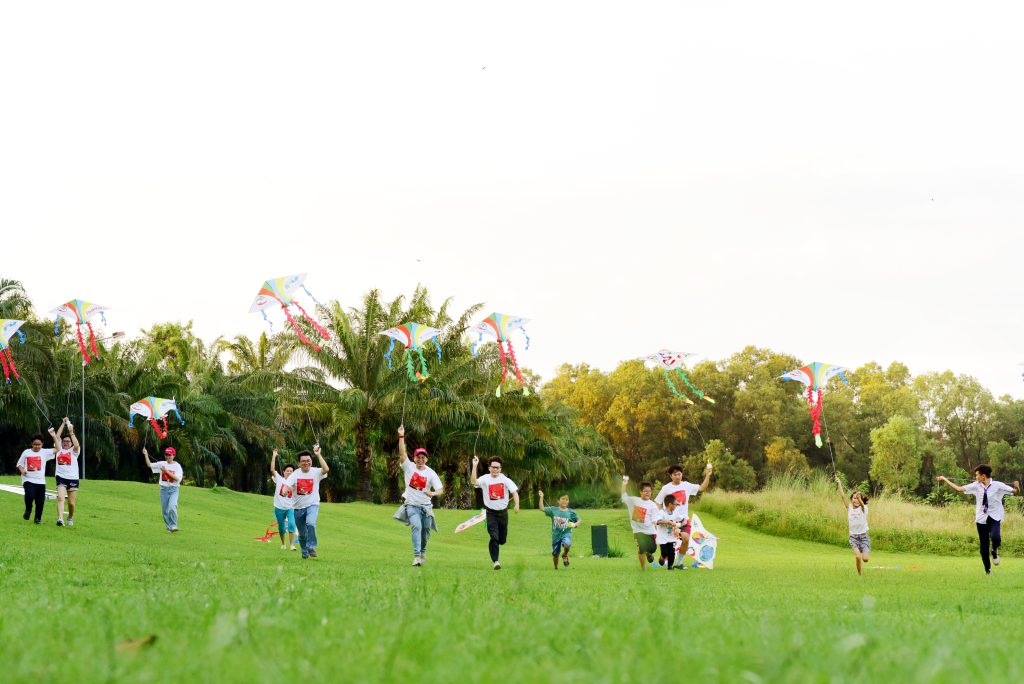 Kites soaring at sunset symbolise hope for underprivileged children.