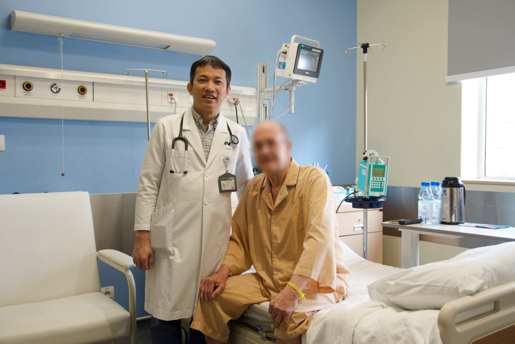 Ho Minh Tuan, MD, PhD, visits patient L.P.E. before his day of discharge