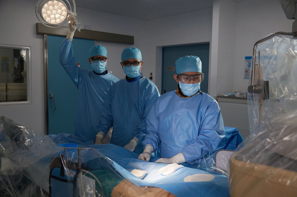 Ho Minh Tuan, MD, PhD performs the stent placement procedure for the patient