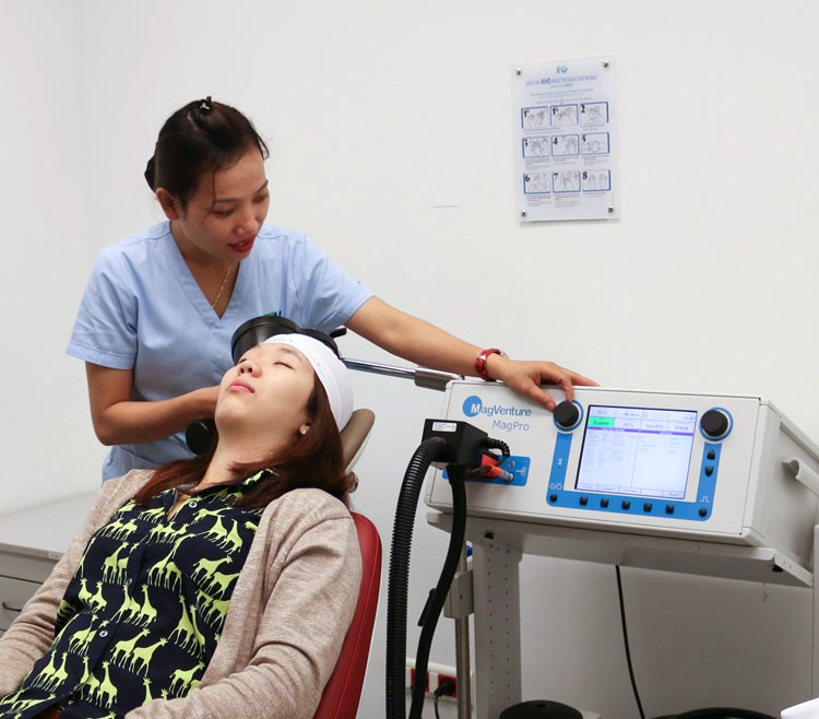 Patient undergoing repetitive transcranial magnetic stimulation (rTMS) therapy.