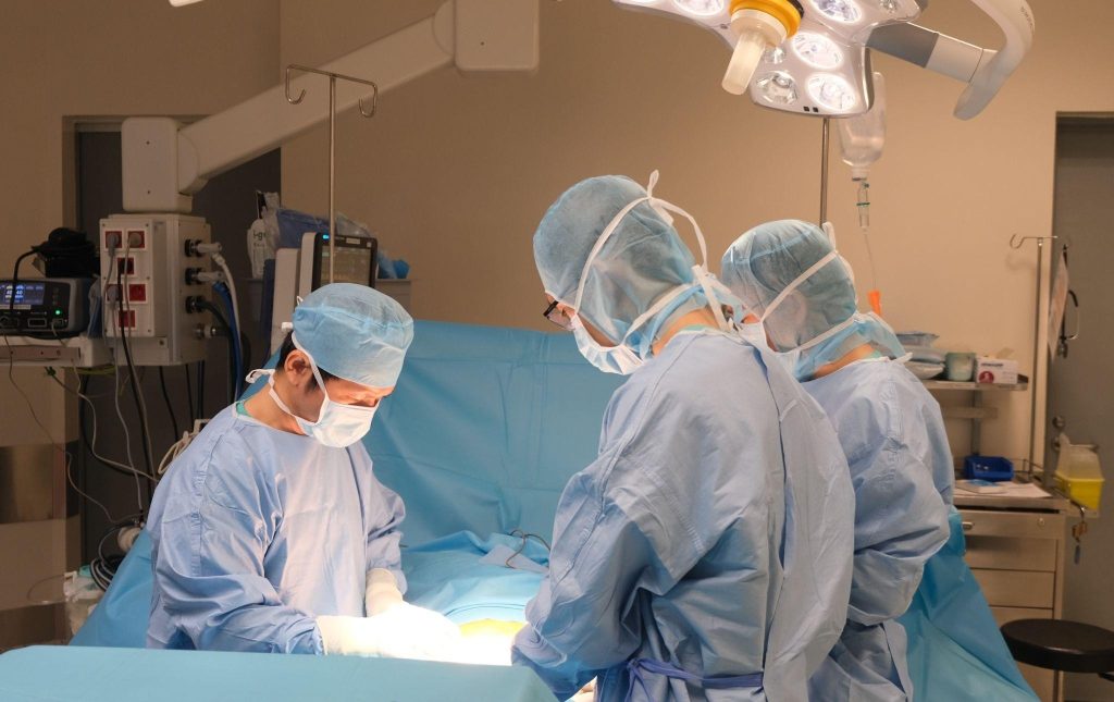 Dr Phan Van Thai (left) performs rectal fistula repair surgery for the patient.