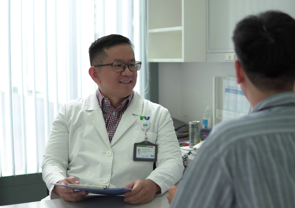 Dr Phan Duy Thuc attentively consults with a patient
