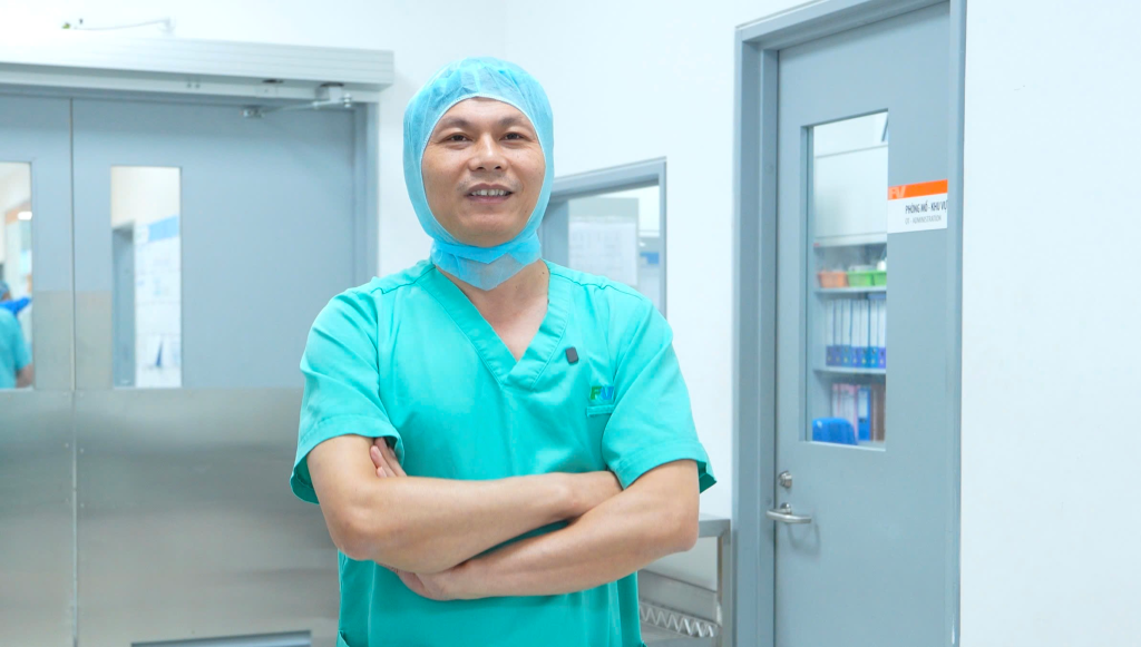 Dr Tran Luong Anh exits the operating room and announces the successful outcome of the surgery