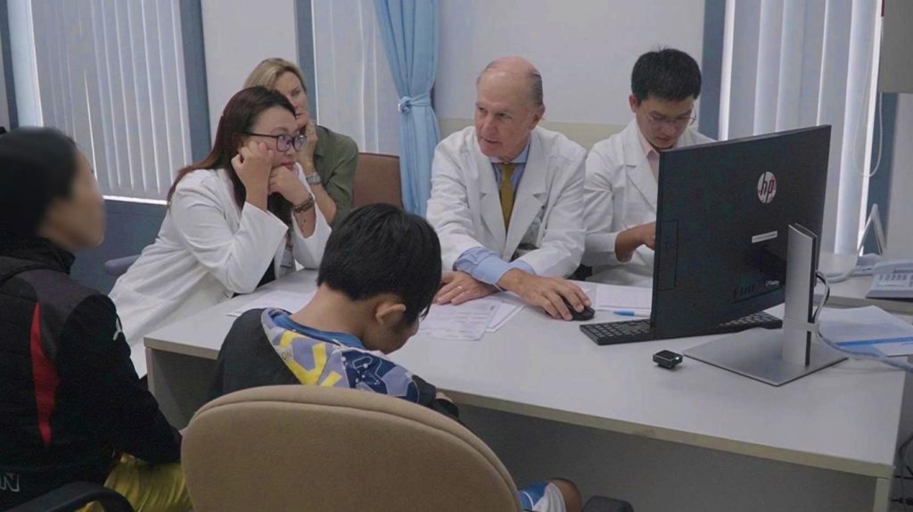 Professor McKay McKinnon and the surgical team examine patient P.A.B.T. before the operation.